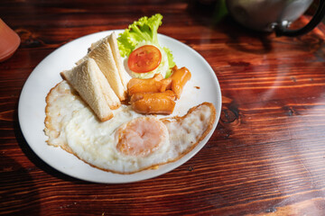 A breakfast consisting of a fried egg with a filling and a toasted bread platter of tomato and lettuce with tomato sauce is delicious.