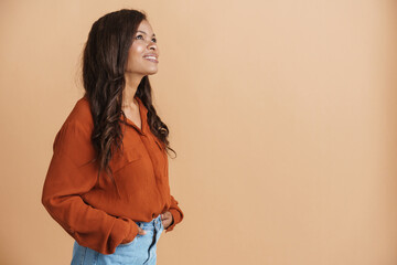 Young black woman wearing shirt smiling and looking upward