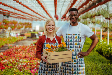 Two gardeners in flower nursery