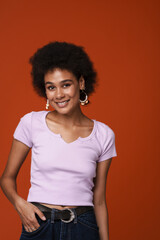 Black young woman in earrings smiling and looking at camera