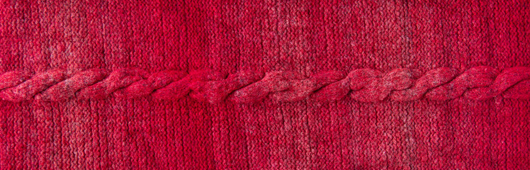 Fototapeta na wymiar Knitted texture with a braid