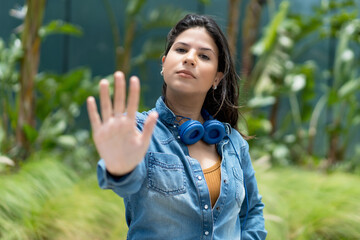 Caucasian female young adult gesturing stop and distance