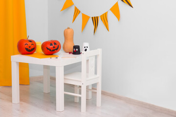 Holiday preparation and handmade party decor. Halloween indoor activity, pumpkin painting