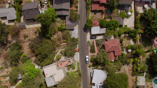 Overhead aerial view of houses and a street in Eagle Rock neighborhood of Los Angeles, California on a pretty summer day.