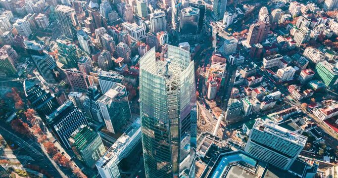 Aerial timelapse of the city with its buildings and the constant traffic of cars on the streets at dawn.