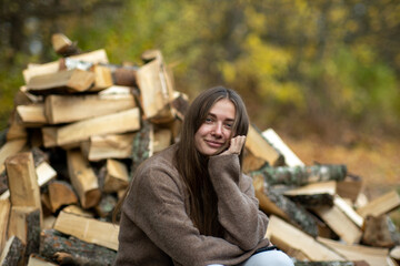 Girl on the background of wooden logs