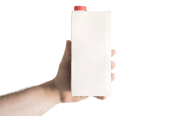 Male arm holds a white blank paper package of milk with red cap. Nutrition. Copy space. Mockup....