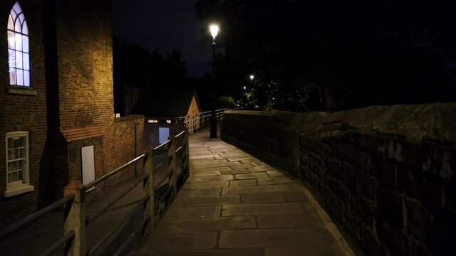 Night walk along the Roman city walls in Chester, UK, whose construction dates back to 70 AD as a fortress in Deva Victrix