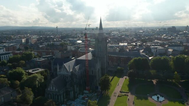 Slide And Pan Shot Of Historic Landmark, St Patricks Cathedral Surrounded By Green Park And Urban Neighbourhood. Dublin, Ireland