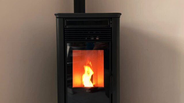Close Up Of A Pellet Wood Stove Heating A Room In Winter.