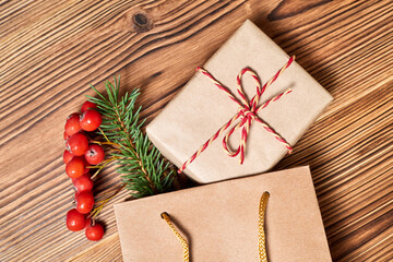 Christmas composition of gift boxes in the paper bag on wooden background