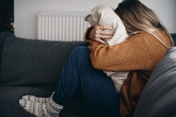 Woman with problems covered under the pillow