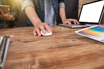 Designer Young asian using graphics tablet while working with computer at studio or office,Graphic design and color swatches and pens on a desk