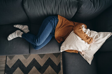 Woman with emotional problems lying on the couch