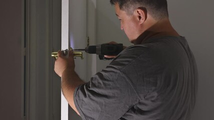 Carpenter installation at interior wood door lock of an apartment