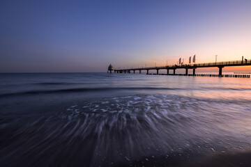 Sunrise at the beach at baltic sea with pier, Zingst, Western-Pomerania, Germany 