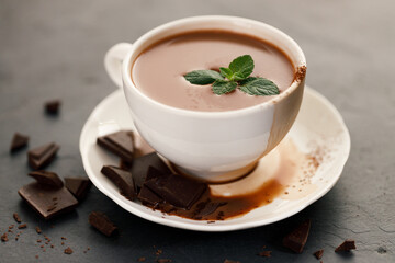 hot chocolate with mint leaves on dark background.