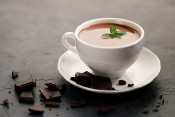 hot chocolate with mint leaves on dark background.