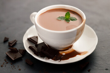 hot chocolate with mint leaves on dark background.