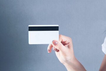 young girl holding a bank card in her hand