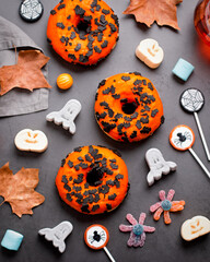 Halloween candy flat lay on stone table, top view