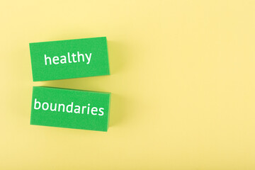 Mental health and healthy boundaries concept on yellow background with copy space