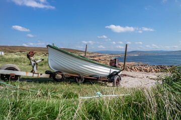 Fishing boat on a rusty trailer by the ocean - obrazy, fototapety, plakaty