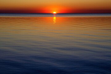 Naklejka na ściany i meble sunset on the background of the sea