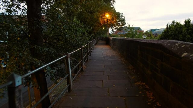 Evening walk along the Roman city walls in Chester, England, UK, whose construction dates back to 70 AD as a fortress in Deva Victrix