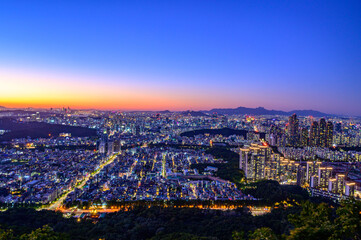 Seoul city night view from the top of the mountain at sunset time