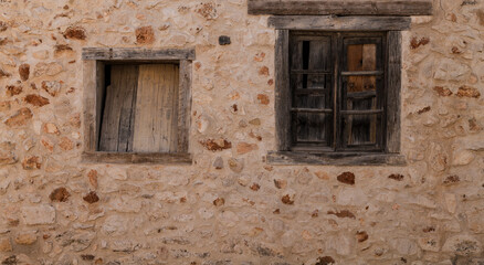 Fototapeta na wymiar Facade of stone building with 2 windows in Nuevo Baztan, Madrid, Spain