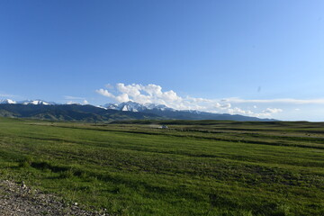 Fototapeta premium Mountain landscape with clouds and road, Kazakhstan, Almaty region