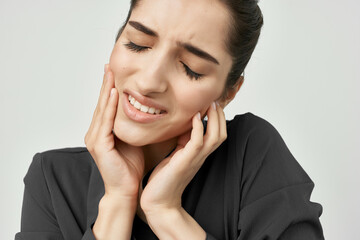 woman in black shirt holding his head depressed health problems