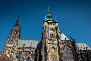 Fototapeta na wymiar Prague Castle and Saint Vitus Cathedral, amazing architectural details and a great construction photographer during a sunny summer day. Landmarks of Europe. Travel photography.