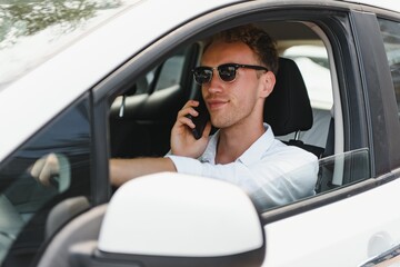 Electric car driver - green energy biofuel concept. Male behind wheel. Man driving new ecofriendly...