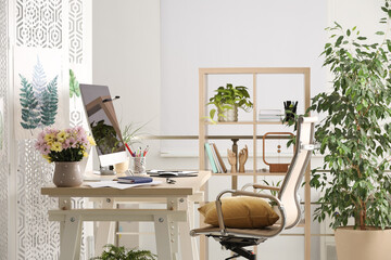 Comfortable workplace with modern computer and stylish furniture in room. Interior design