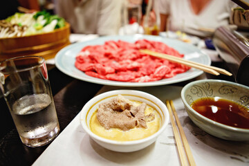 Shabu-shabu is a Japanese nabemono hotpot dish of thinly sliced meat and vegetables boiled in water and served with dipping sauces. Preparation of shabu shabu