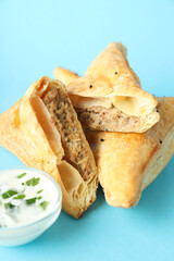 Golden samsa with ingredients on blue background