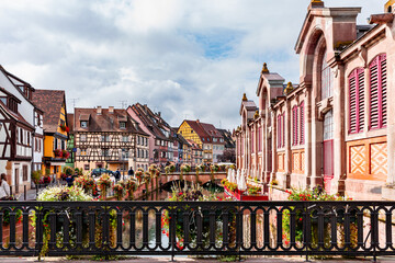 Colorful historic houses by the lake and bridge in Colmar France