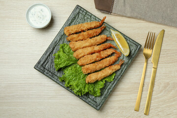 Сoncept of tasty food with deep-fried shrimp on wooden background