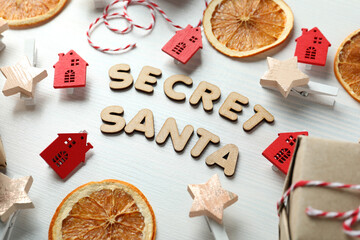 Secret Santa and Christmas composition on white wooden background