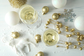 Fototapeta na wymiar Concept of New Year celebration with champagne on white wooden background