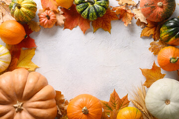 Autumn frame of colorful pumpkins and falled leaves on white background. Seasonal fall border with space for text. Top view. Thanksgiving Day. Flat lay.