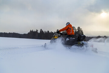 Athlete on a snowmobile.