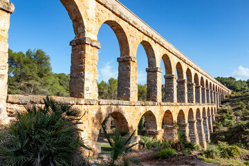 Obraz premium Roman aqueduct of Tarragona, also known as (Pont del Diable) or de les Ferreres. The purpose of this magnificent construction was to collect water from the Francoli River and transport it to the city
