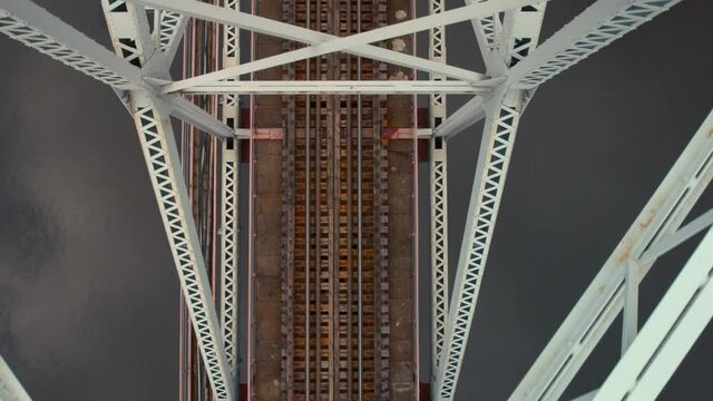 Metal railway train arc bridge over the river Belarus Orsha Dnieper River. rusty rails, autumn Aerial top down footage from drone