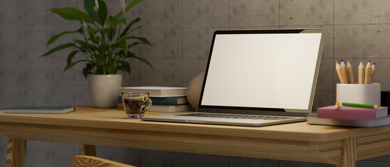 Modern simple home workspace with laptop blank screen mockup and decor on wooden desk.