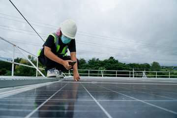 Energy woman working on a roof with solar panels.
