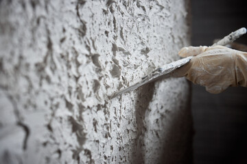 Plastering the wall. Hand holding a spatula with construction mix .Internal construction and finishing works