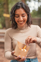 vertical portrait of a beautiful young indian woman eating french fries
